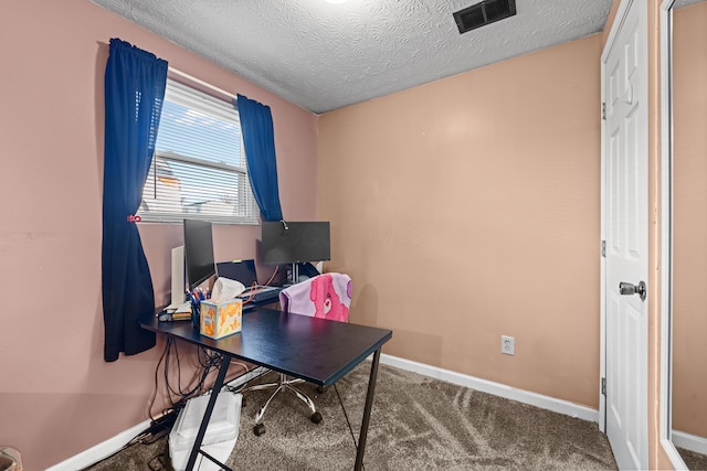 home office featuring carpet and a textured ceiling