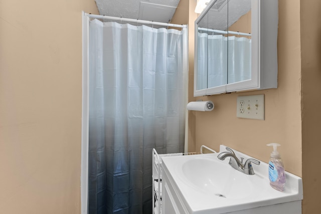 bathroom with vanity and curtained shower