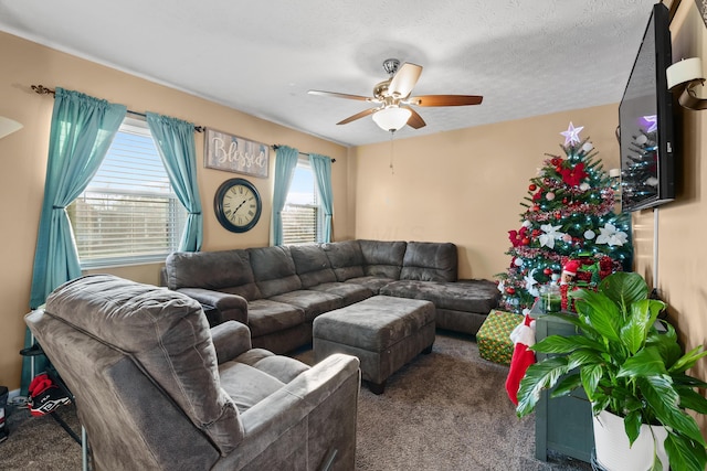 carpeted living room featuring ceiling fan, a textured ceiling, and a wealth of natural light