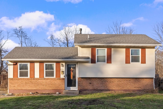 tri-level home with a front yard