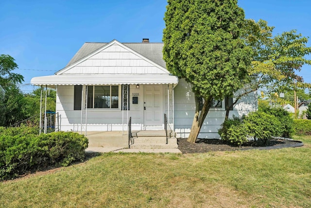 bungalow-style home with a front yard