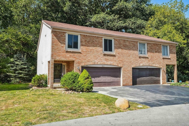 view of front of home with a front yard and a garage