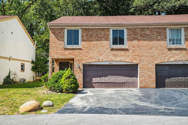 view of front facade with a front yard and a garage