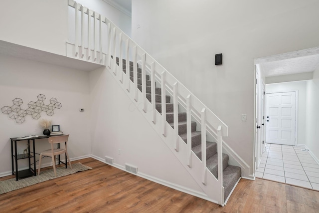 staircase featuring wood-type flooring