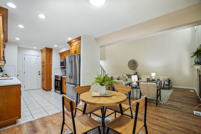 dining area featuring sink and light hardwood / wood-style floors