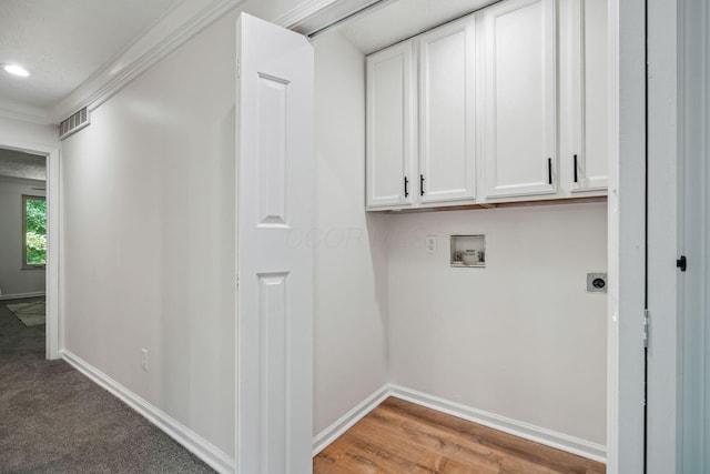 washroom with cabinets, washer hookup, hookup for an electric dryer, and ornamental molding