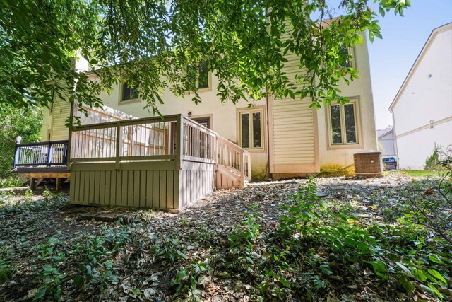 rear view of house with central air condition unit and a deck