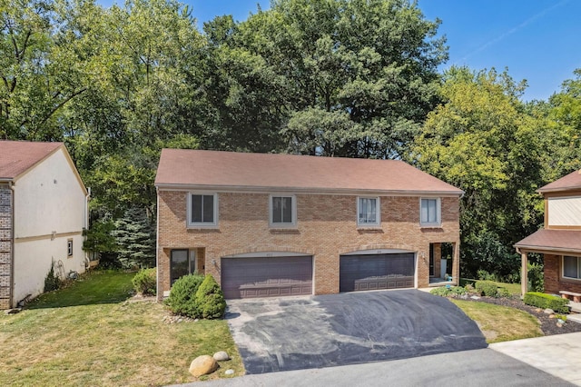 view of front of home with a garage and a front lawn