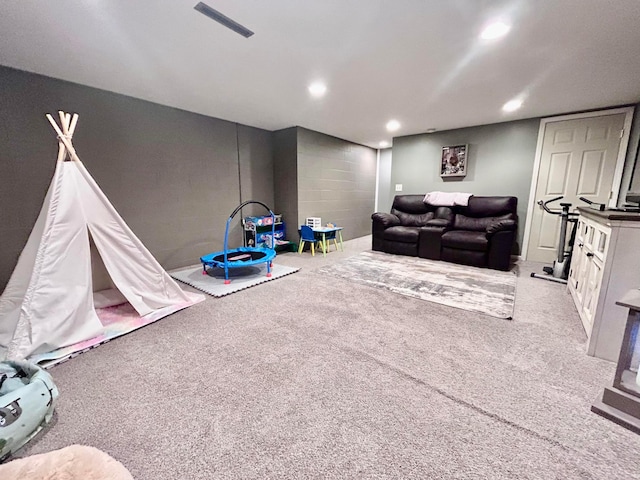 recreation room with light colored carpet