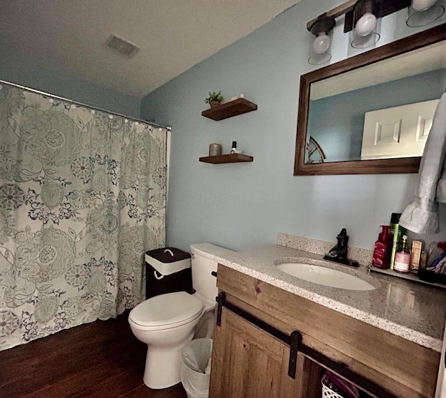 bathroom featuring hardwood / wood-style flooring, vanity, and toilet