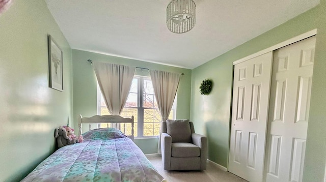 bedroom featuring light colored carpet and a closet