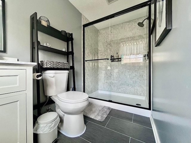 bathroom featuring vanity, an enclosed shower, and toilet