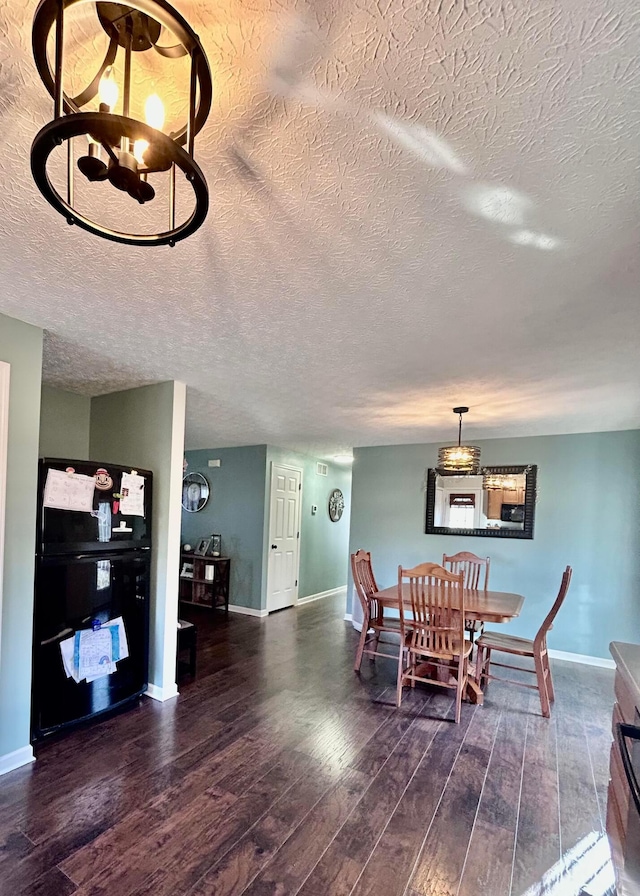 dining space featuring dark hardwood / wood-style flooring and a textured ceiling