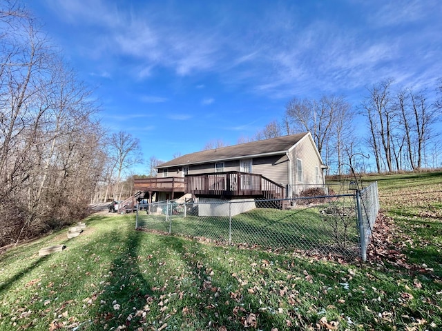 rear view of house with a yard and a wooden deck