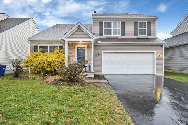 view of front of home with a garage and a front lawn