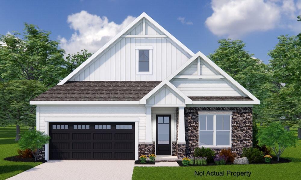 view of front facade featuring a front yard and a garage