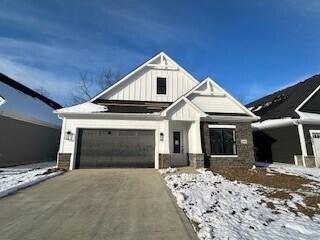 view of front of house featuring driveway, an attached garage, and board and batten siding