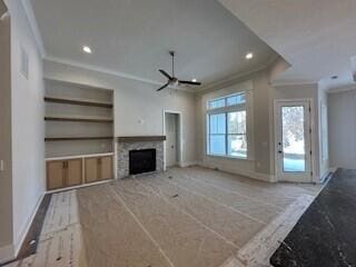 unfurnished living room with ornamental molding, recessed lighting, baseboards, and built in shelves