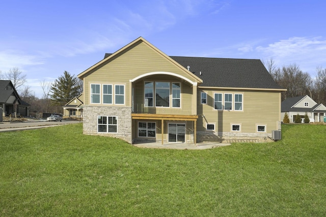 back of property featuring a lawn, central air condition unit, and a patio area