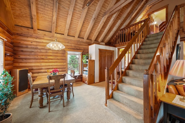 dining space featuring wooden ceiling, rustic walls, beam ceiling, and stairs