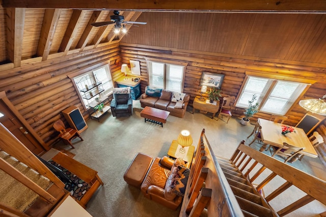 living area featuring beam ceiling, carpet flooring, ceiling fan, high vaulted ceiling, and wooden ceiling