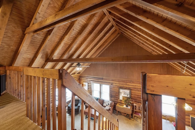 interior space with carpet floors, high vaulted ceiling, log walls, and beam ceiling