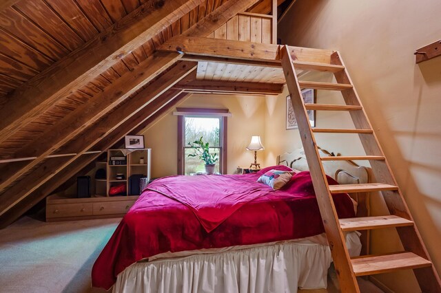 carpeted bedroom with vaulted ceiling with beams and wood ceiling