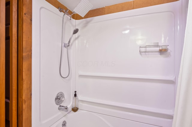 bathroom featuring shower / bathtub combination with curtain