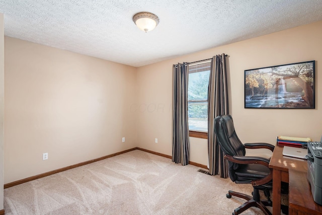 office area featuring a textured ceiling and light carpet