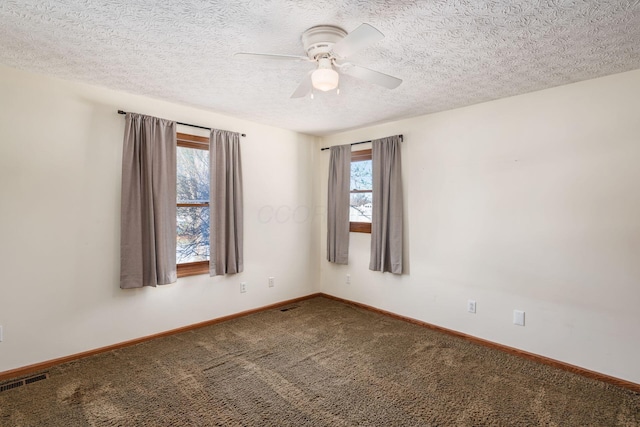 carpeted empty room with a textured ceiling and ceiling fan