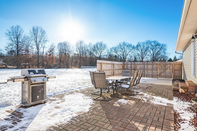 snow covered patio featuring area for grilling