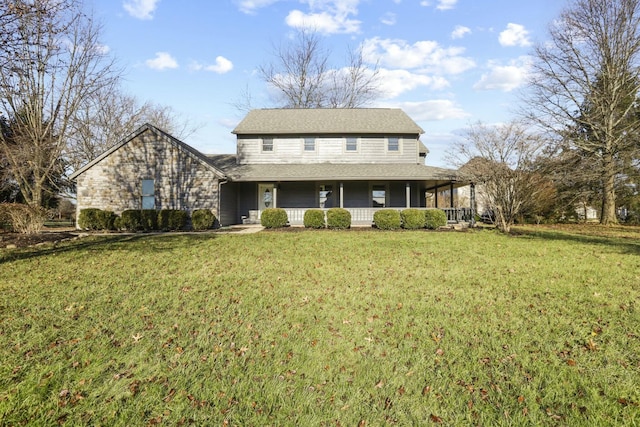 view of front of property with covered porch and a front yard