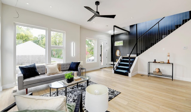 living room with light hardwood / wood-style floors and ceiling fan