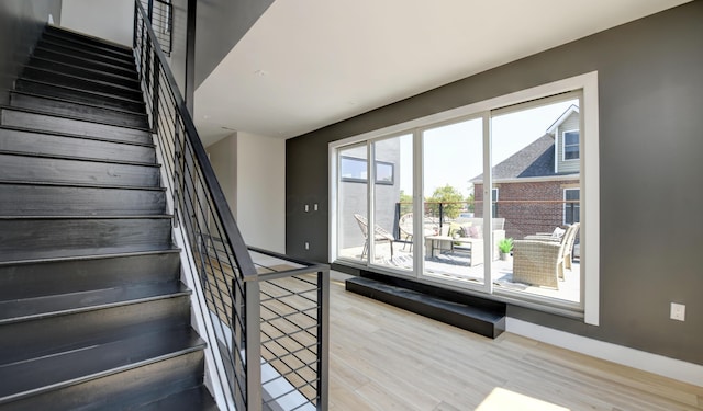 stairway with hardwood / wood-style floors