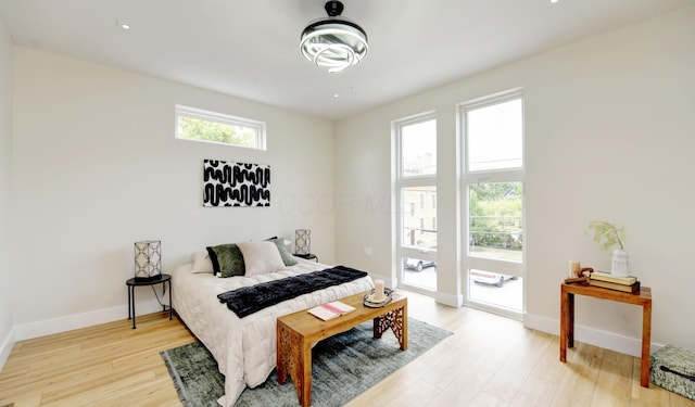 bedroom featuring access to outside and light hardwood / wood-style floors