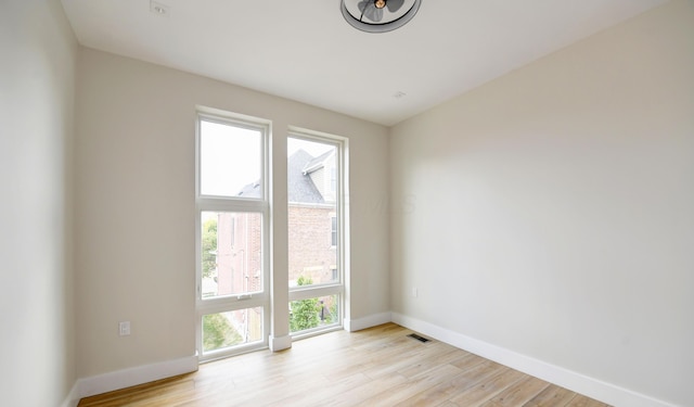 spare room with light hardwood / wood-style flooring