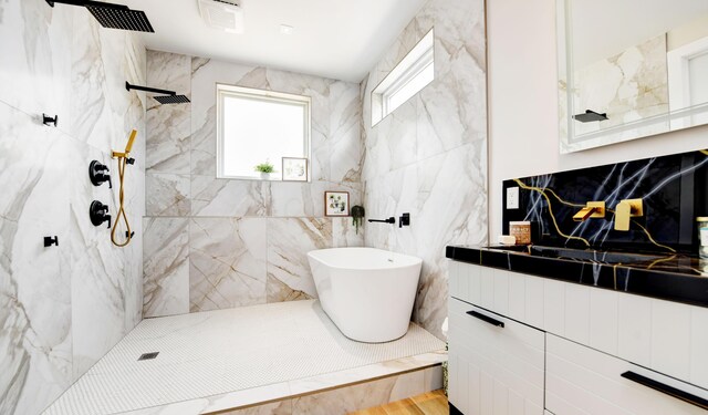 bathroom featuring shower with separate bathtub