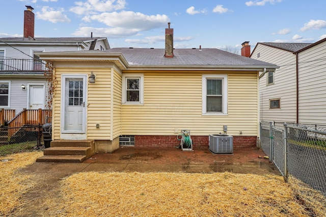 back of house with central AC