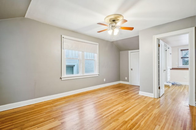 unfurnished room with light wood-type flooring, ceiling fan, and lofted ceiling