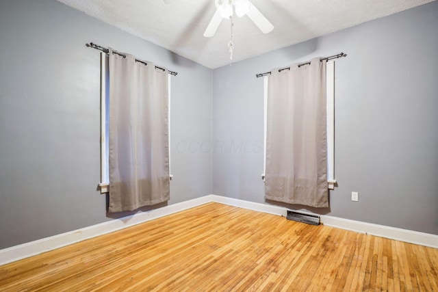 unfurnished room with hardwood / wood-style floors, a textured ceiling, and ceiling fan