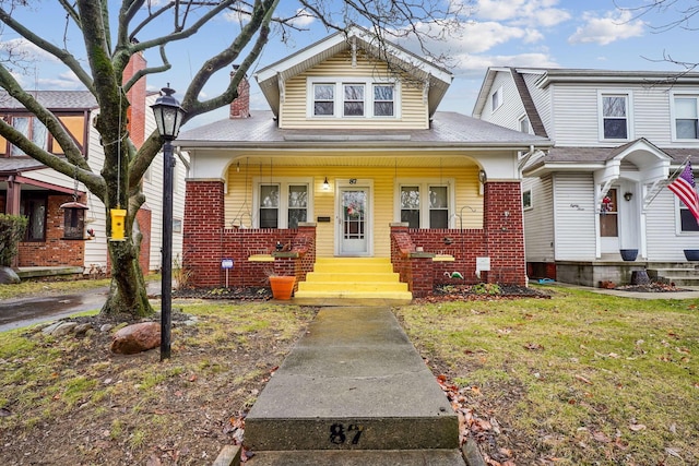 bungalow-style home featuring a front yard