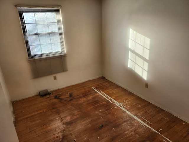 unfurnished room with dark wood-type flooring