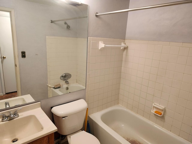 full bathroom with vanity, toilet, and tiled shower / bath