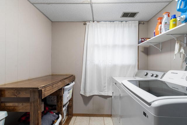 laundry room featuring washer and clothes dryer and light tile patterned flooring