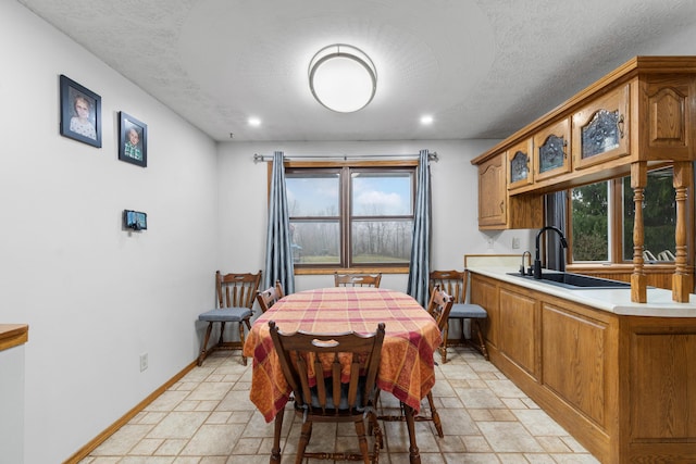 dining area featuring sink and a textured ceiling