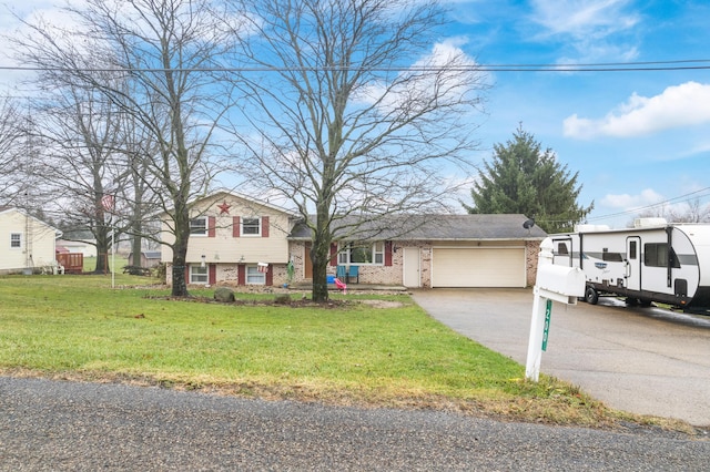 split level home with a front lawn and a garage