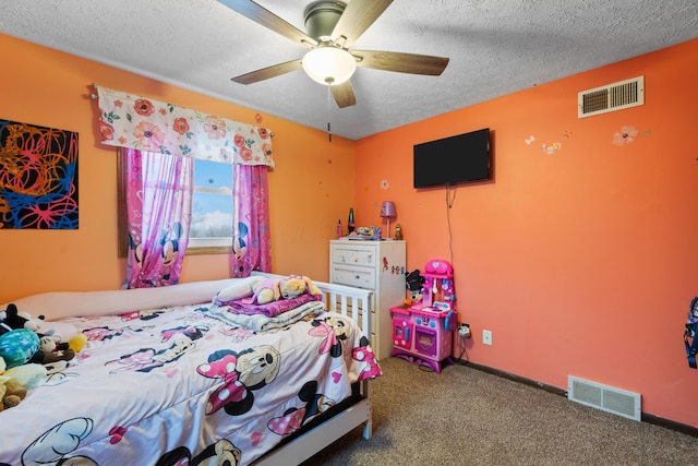 bedroom featuring a textured ceiling, carpet floors, and ceiling fan