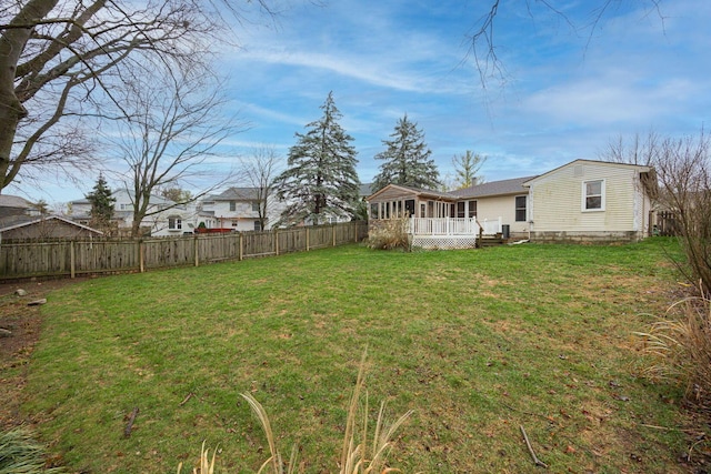 view of yard featuring a sunroom and a wooden deck