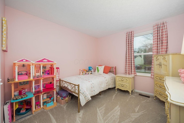 bedroom featuring carpet and a textured ceiling