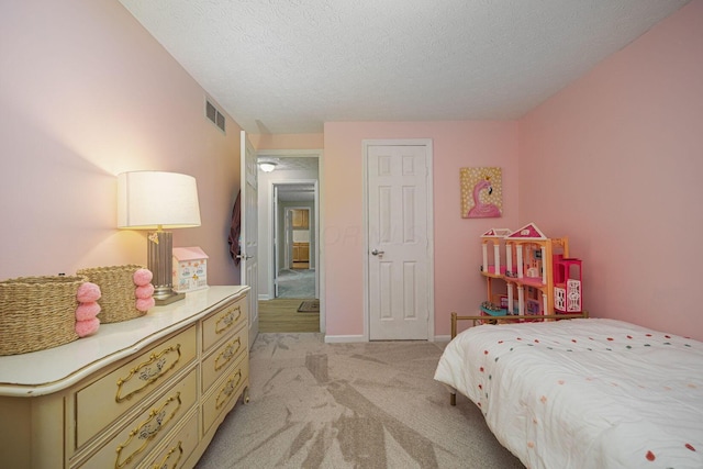 carpeted bedroom with a textured ceiling